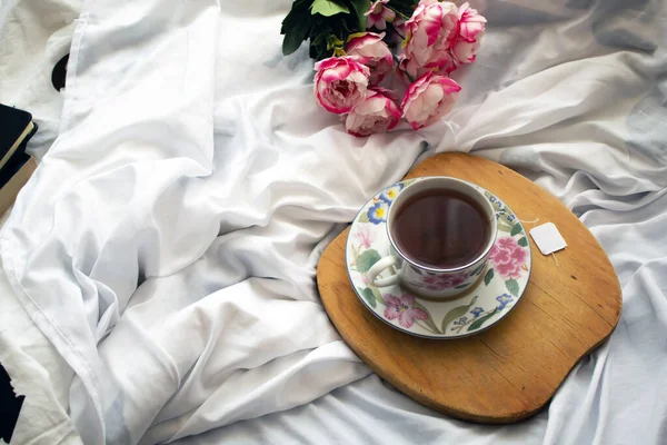 tea in the bed, ready for relaxation some peonies in the back