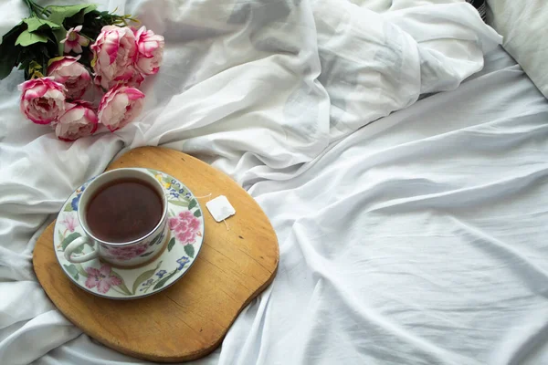 tea in the bed, ready for relaxation some peonies in the back