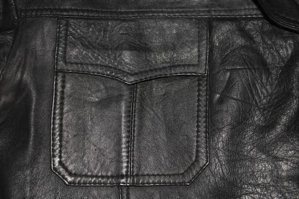 黒い革のジャケットのポケットのテクスチャ背景 — ストック写真