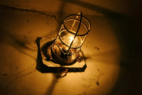 Old industrial lamp in an abandoned basement.