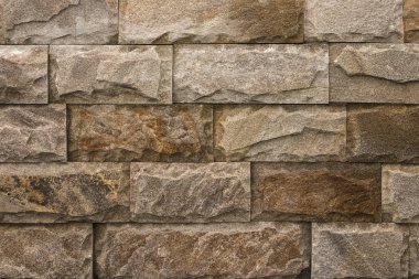 Doğal taştan yapılmış kahverengi tuğla duvar arka plan.