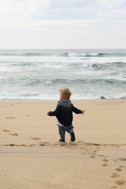 Plajda çalışan şirin küçük çocuk