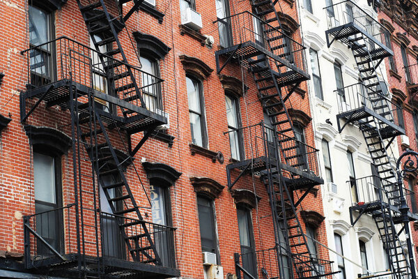 Facades of the buildings in new York city with cast-iron staircases