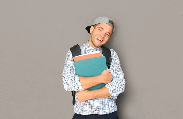 Student in plaid shirt and baseball cap