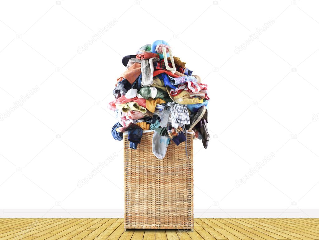 Beige straw basket full of dirty Laundry