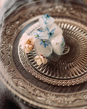 buz küpleri ve elma ağacı çiçekleri dondurulmuş mavi yaprakları ile yaratıcı kompozisyon 