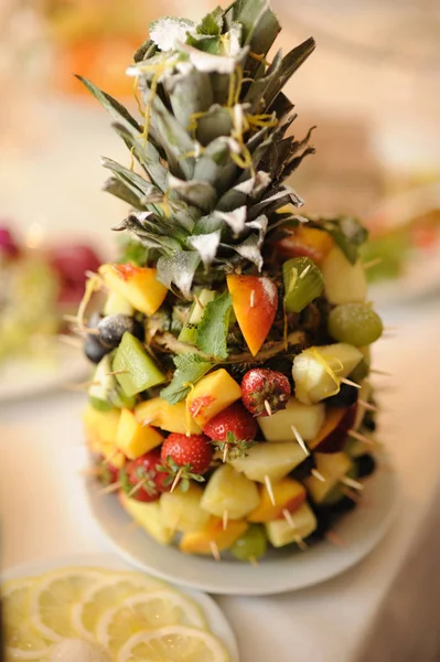 creative composition with fresh fruits in shape of pineapple