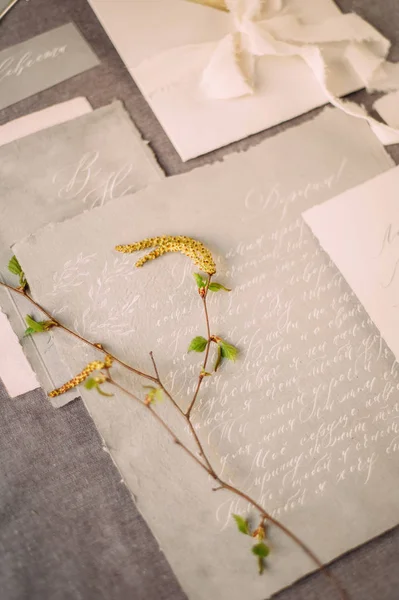wedding calligraphy cards and spring twigs, flat lay