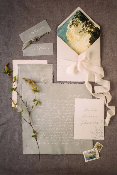 wedding calligraphy cards and spring twigs, flat lay