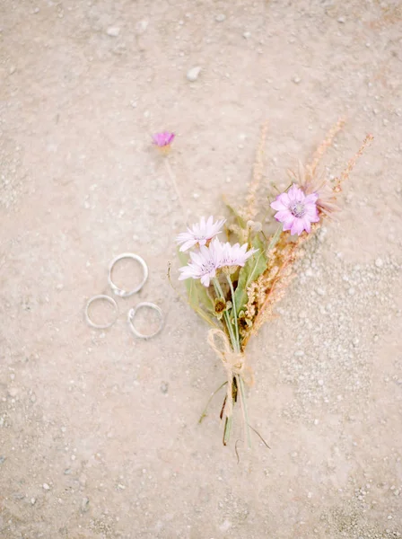 Golden wedding rings and pink flowers, eternal love concept
