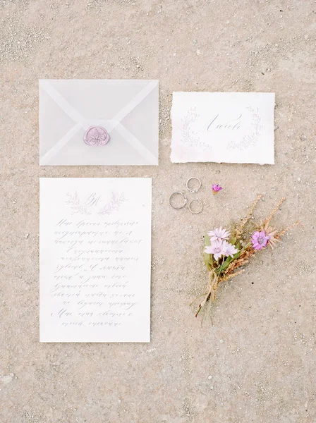 set of wedding calligraphy cards, wedding rings and flowers
