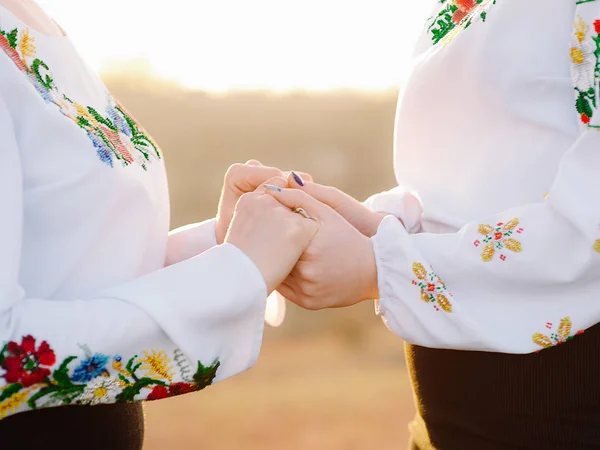 Two Women Embroidered White Shirts Holding Hands Outdoor — Stock Photo, Image