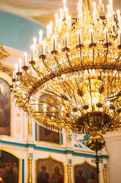 beautiful decorated ceiling in old church with big golden chandelier