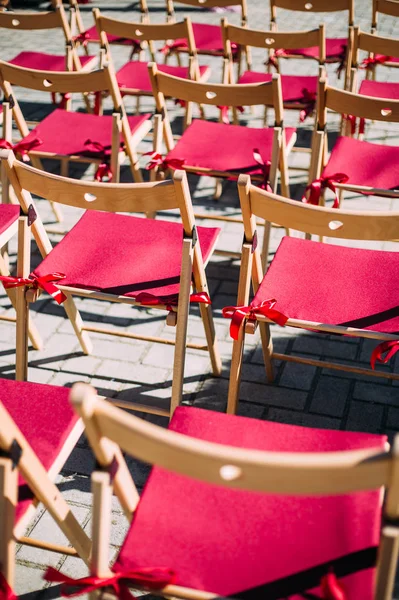 pattern of red empty chairs outdoor
