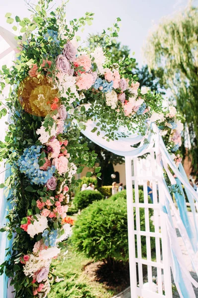 Wedding arch floral decoration, arch of white roses close up on green grass,  country wedding ceremony, outdoor wedding