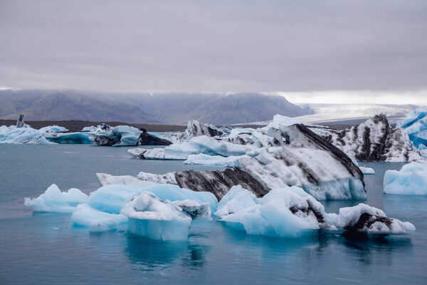 Icebergs in Jokulsarlon lagoon beneath Breidamerkurjokull glacier Sudhurland, Iceland