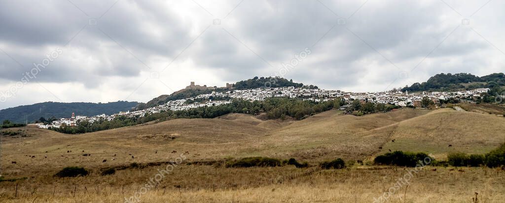 View of whitewashed village, pueblo blanco and surrounding countryside with a castle on top of the hill, Jimena de la Frontera, Cadiz Province, Andalusia, Spain, Western Europe.