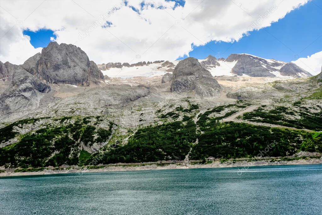 Alpine landscape in the Dolomites, Italy. Glacier Marmolada and Lago di Fedaia.