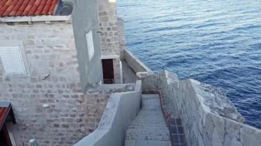 Hırvatistan 'ın Dubrovnik kentinde, Adriyatik Denizi' nin Dalmaçya kıyısındaki antik ve savunmacı şehir duvarında yürüyün.