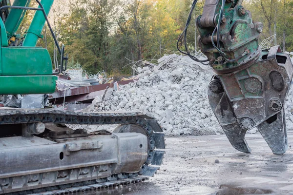 demolition excavator rips off a building