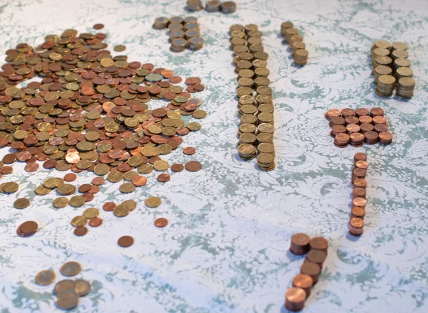 Small change Euro coins are counted by a woman