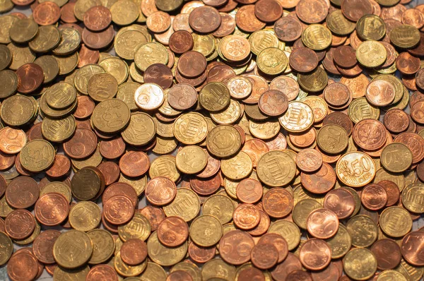 Small change Euro coins are counted by a woman