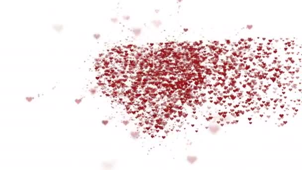 Red heart is isolated on white background. Accumulation of little hearts creates one large heart. Appearing from the right side. The whole heart is being zoomed. Close up. Copy space. — Stock Video