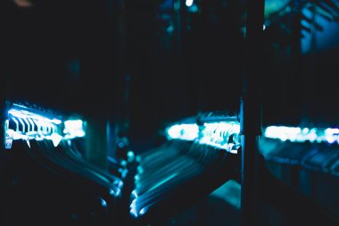 hangers hangers for clothes illuminated with neon tape hanging in a row