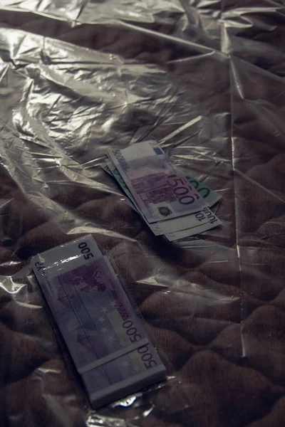 money lying on the bed covered with film