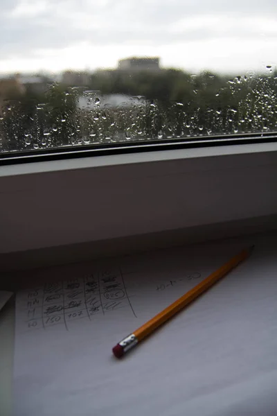 Pencil Lying Scribbled Paper Windowsill Rainy Day Glass Raindrops Windows — Stock Photo, Image