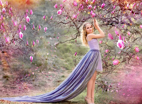 Girl and magnolia in the garden — Stock Photo, Image
