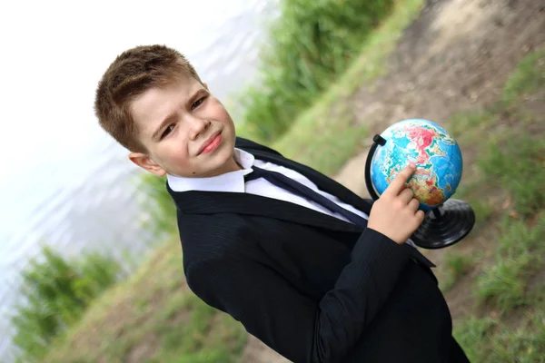 School jongen kijkt naar de wereld en dromen in de natuur — Stockfoto