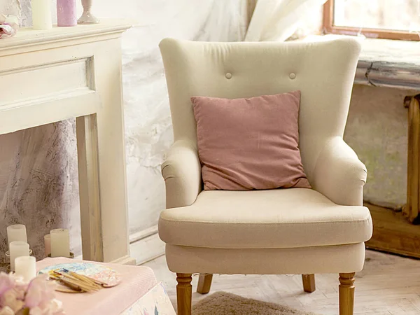 comfortable beige armchair in a modern classic designer interior