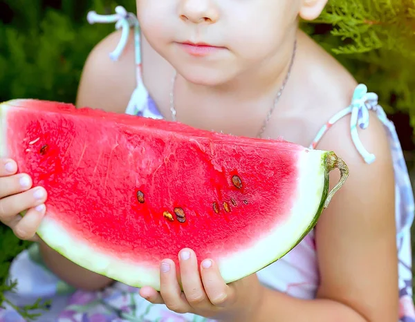 Red ripe watermelon in the hands little caucasian girl, large slice. Childhood. Happiness. Summer. Recreation. Healthy eating concept.