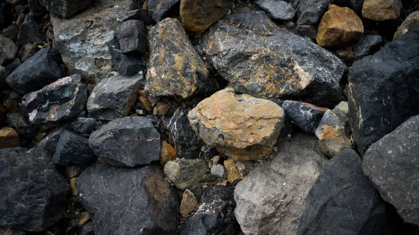 many stone on the beach in day time