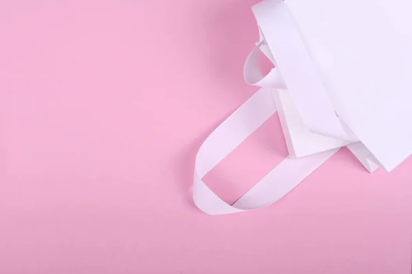 Caja de regalo blanca en bolsa de regalo blanca sobre fondo rosa — Foto de Stock