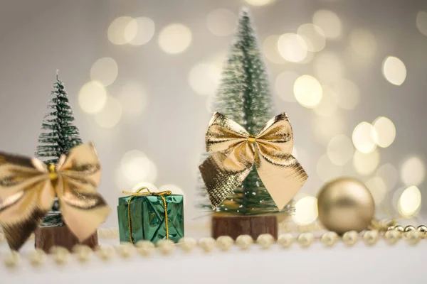 Little Christmas trees decorated and gifts for the new year on the bokeh background, new year mood 2021 — Stock Photo, Image