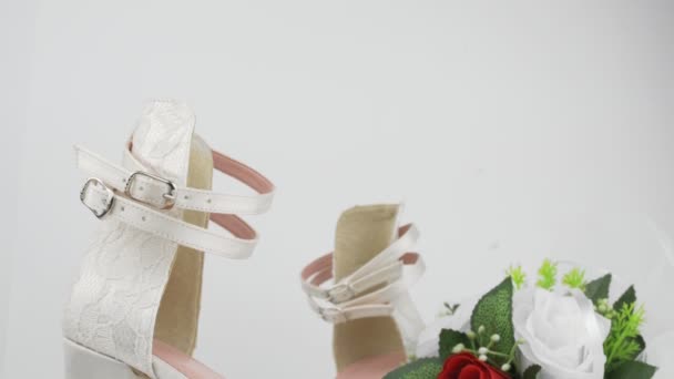 Elegante Hochzeitsschuhe Und Blumenstrauß Mit Roter Rose Auf Weißem Hintergrund — Stockvideo