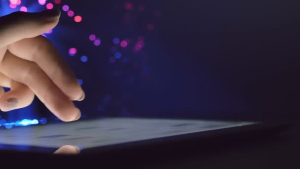 Woman Hand Touching Browsing Tablet Device Dark Room Colorful Blurry — Stock Video