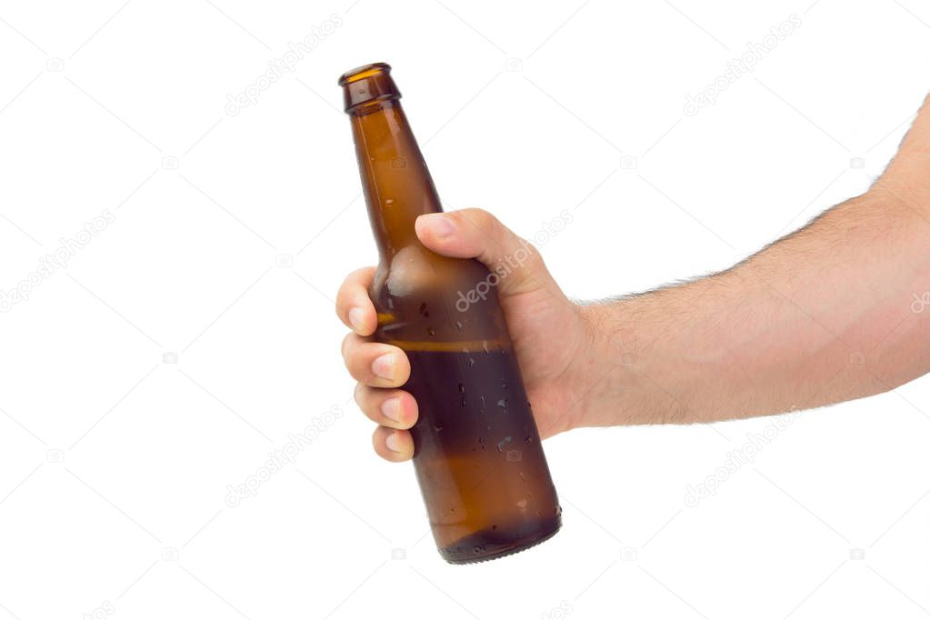 Hand Holding Brown Ice Cold Wet Condensated Lager Beer Bottle With Beer And Foam Inside Isolated On White