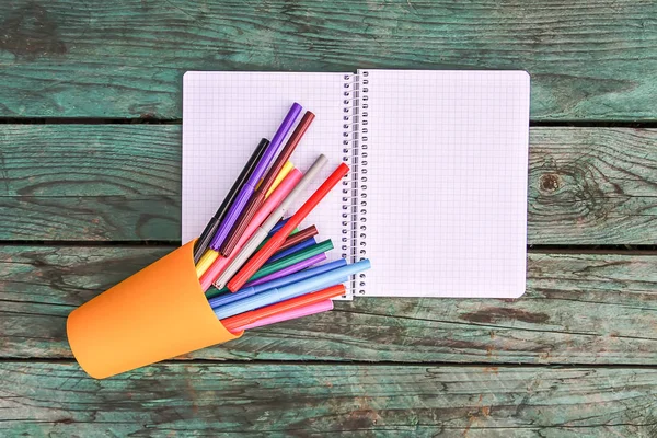 School supplies. Back to School design elements. Colorful markers and white empty paper sheet.