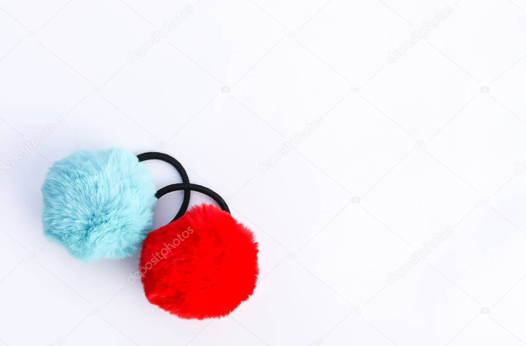 Colorful fluffy pompons on white background. Fashion decoration festive template. Design element for poster, banner, web, greeting card.