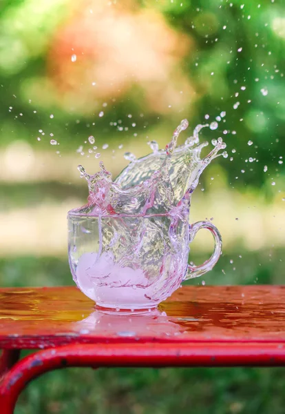 Splash Of Cool Fresh Water With Ice Cube In The Transparent Glass Cup In The Table Outoors In Summer Day Stock Images Page Everypixel