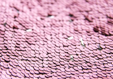 Ilık renklerde parlak, parlak, engebeli pullar. Moda kumaşı arkaplanı.