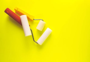 Repair tools on bright background. Foam rollers.