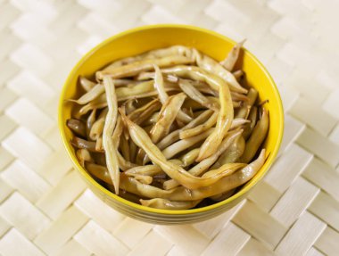 Sarı seramik bardakta kızarmış uzun Fransız fasulyesi..