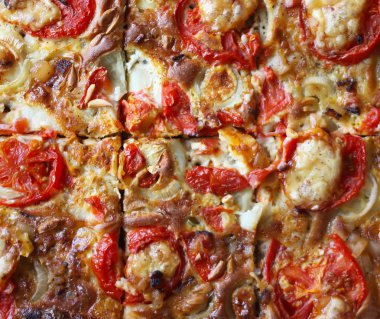 Rustic pizza with salami, tomatoes and cheese