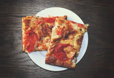 Rustic pizza with salami, tomatoes and cheese