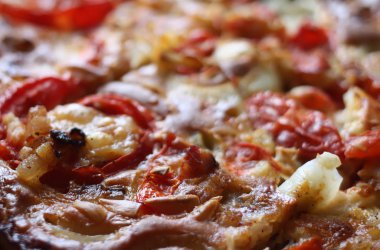 Rustic pizza with salami, tomatoes and cheese