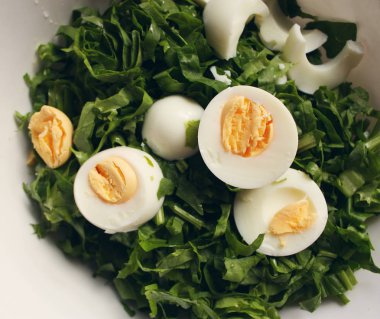 Salad with eggs and green spinach close up